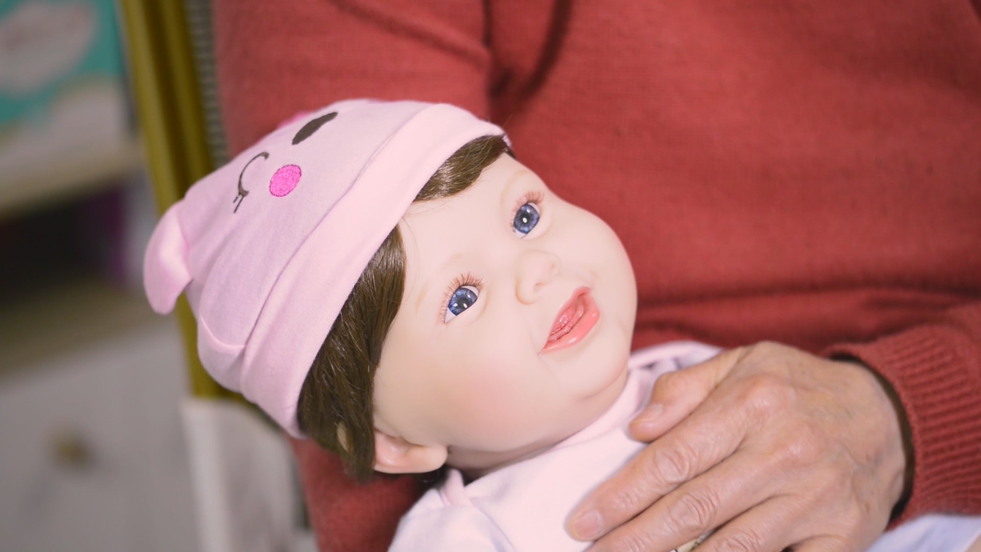 elderly woman holding therapy doll